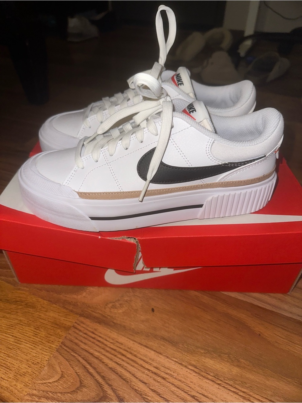 Nike White Low-Top Sneakers with Black Swoosh and Tan Stripe